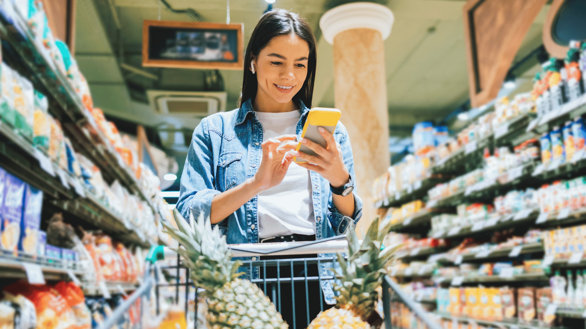 femme qui fait ses courses en regardant son téléphone
